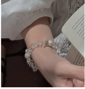 Detailed view of S925 silver beaded bracelet with white crystals on a model wrist