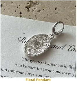 Macro view of S925 sterling silver daisy oval embossed pendant with center zircon