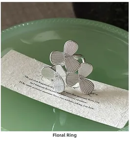Close-up of S925 sterling silver ring with small flowers and sparkling cubic zirconia