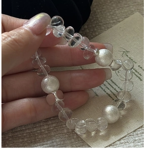 Close-up of S925 silver beaded bracelet with clear crystals and white frosted beads