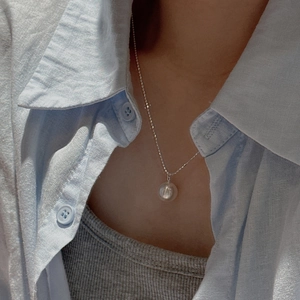 Minimalist S925 sterling silver necklace featuring a large round pearl on model