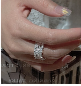 Close-up of S925 sterling silver beaded ring with woven texture on model finger