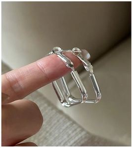 Close-up of S925 sterling silver square hoop earrings with polished finish and hallmark