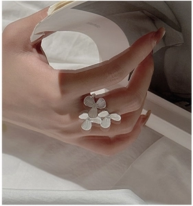 Macro detail of S925 silver ring featuring three floral petals with ribbed textures
