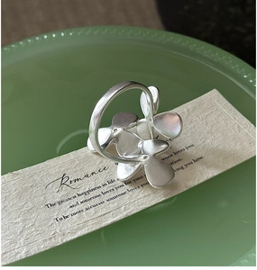 Macro shot of S925 sterling silver floral ring with a minimalist matte finish