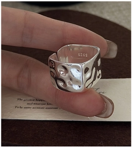 Detailed view of wide S925 sterling silver ring featuring a unique hammered texture finish