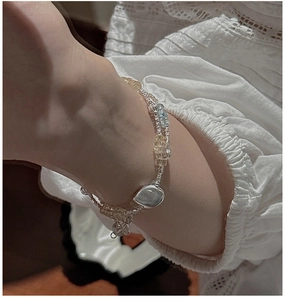 Macro detail of S925 silver beaded bracelet with blue aquamarine and citrine on lace sleeve