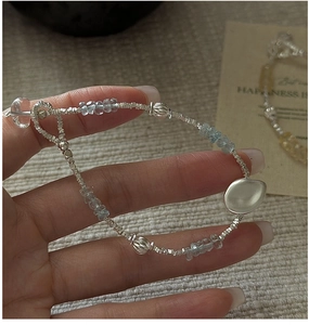 Macro detail of S925 sterling silver beaded bracelet with light blue aquamarine stones
