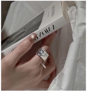 Close-up of S925 silver square rings featuring hammered texture and micro-pave stones