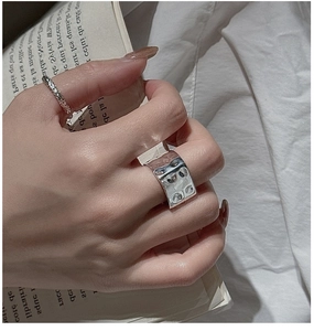 Detail of S925 silver ring set with irregular hammered and textured woven band