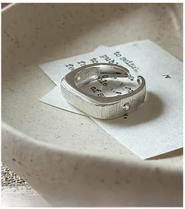 Macro shot of S925 sterling silver ring with brushed matte texture and small zircon