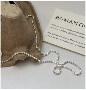 Detail of S925 sterling silver beaded necklace showing polished metallic round pearls
