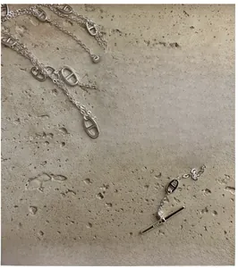 Detail view of S925 silver pig nose necklace with T-bar clasp on stone texture