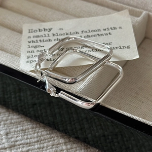 Minimalist S925 sterling silver square hoop earrings on a vintage jewelry box