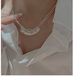 Detail of S925 sterling silver triple-layered necklace with clustered small ring pendant