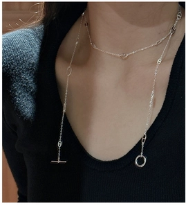 Detail of S925 sterling silver pig nose chain necklace on black sweater for women