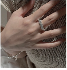 Detailed macro view of S925 sterling silver ring with handmade hammered texture and chain