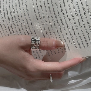 Minimalist wide S925 sterling silver ring with hammered texture worn on thumb