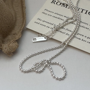 Elegant S925 sterling silver beaded sweater necklace on romantic card background