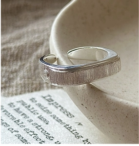 Macro shot of brushed S925 sterling silver ring with delicate single zircon stone detail