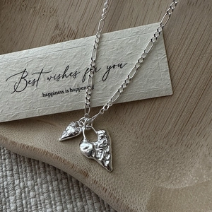 S925 sterling silver heart necklace with molten texture and figaro chain detail