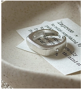 Close-up of S925 sterling silver ring with matte brushed finish and a small inset stone