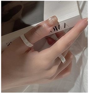 Close-up of textured S925 sterling silver hexagram rings with a matte hammered finish