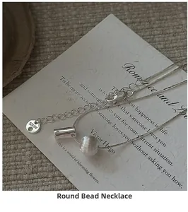 Macro shot of S925 sterling silver necklace featuring a matte bead and AG925 hallmark