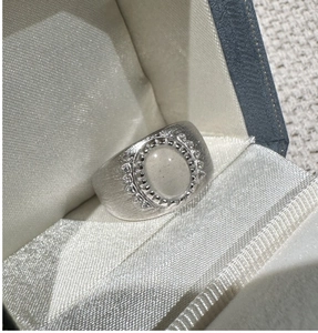 Macro shot of S925 sterling silver brushed ring featuring a white moonstone in gift box