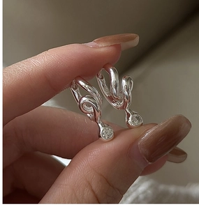 Close-up of S925 sterling silver twisted hoop earrings with sparkling round cubic zirconia