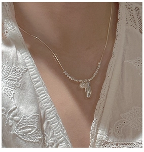 Detail of S925 sterling silver beaded necklace featuring a white shell pearl and metal charm