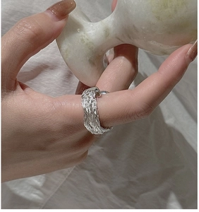 Close-up of S925 sterling silver woven ring worn on finger with vintage braided texture