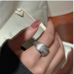 Macro detail of vintage S925 silver ring with oval jadeite and brushed matte texture