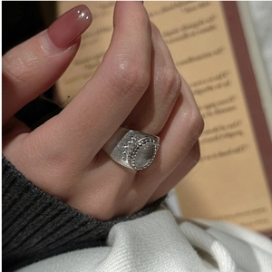 Detail of vintage S925 silver wide ring featuring oval gemstone and brushed metal finish