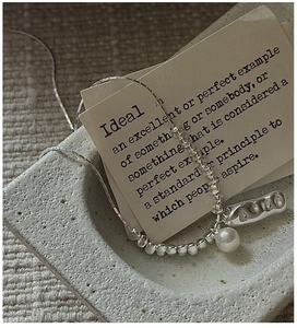 Detail of S925 sterling silver necklace with irregular bar pendant and round shell pearl