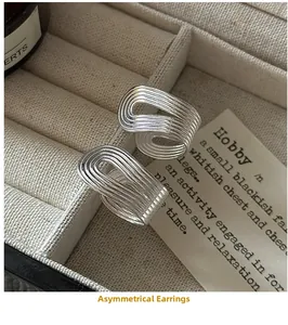Detailed view of S925 sterling silver irregular earrings with textured parallel lines
