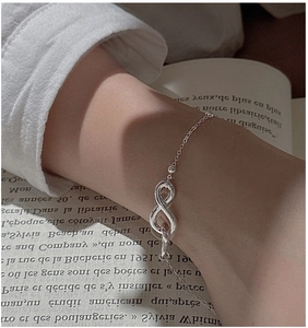 Close-up of S925 sterling silver infinity symbol bracelet worn on a woman's wrist