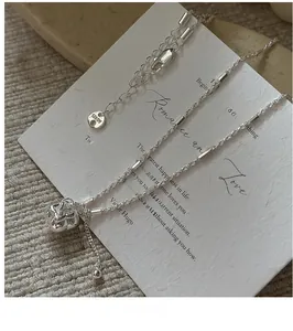 Macro shot of S925 sterling silver persimmon pendant necklace on a poetic art card