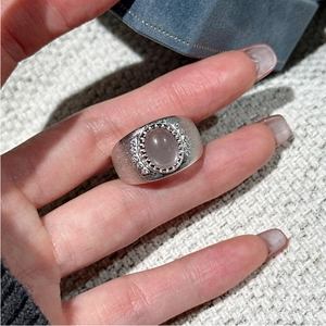 Close-up of vintage S925 silver ring featuring pink gemstone and matte finish on finger