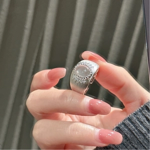Detail of S925 silver wide band ring with brushed texture and oval gemstone
