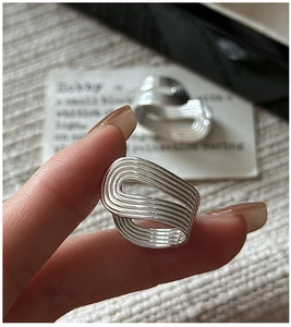 Macro shot of silver minimalist multi-layer wrapped ring with fine industrial texture