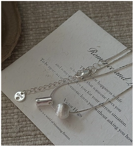 Close-up of S925 sterling silver snake chain with matte brushed bead on a white card
