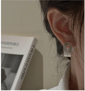 Close-up of S925 sterling silver U-shape earrings with vintage textured vertical stripes