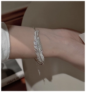 Detail showing vintage S925 sterling silver feather bracelet with intricate textures