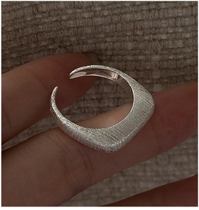 Detail of S925 sterling silver ring featuring unique brushed metal texture and open design