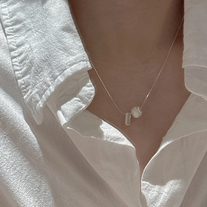 Minimalist S925 sterling silver necklace featuring a brushed ball pendant on a model