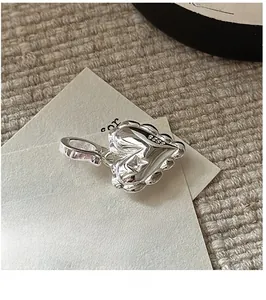 Macro detail of S925 sterling silver heart pendant with star engraving and mirror finish