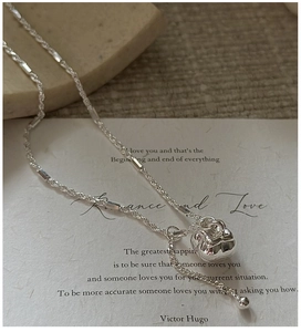 Detailed macro of S925 sterling silver rope chain and textured spherical pendant