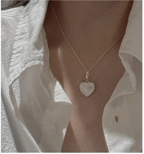 Detailed close-up of S925 sterling silver heart pendant with textured vertical stripes