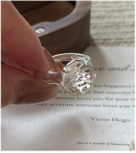 Detailed view of S925 sterling silver ring featuring a textured band and white crystal
